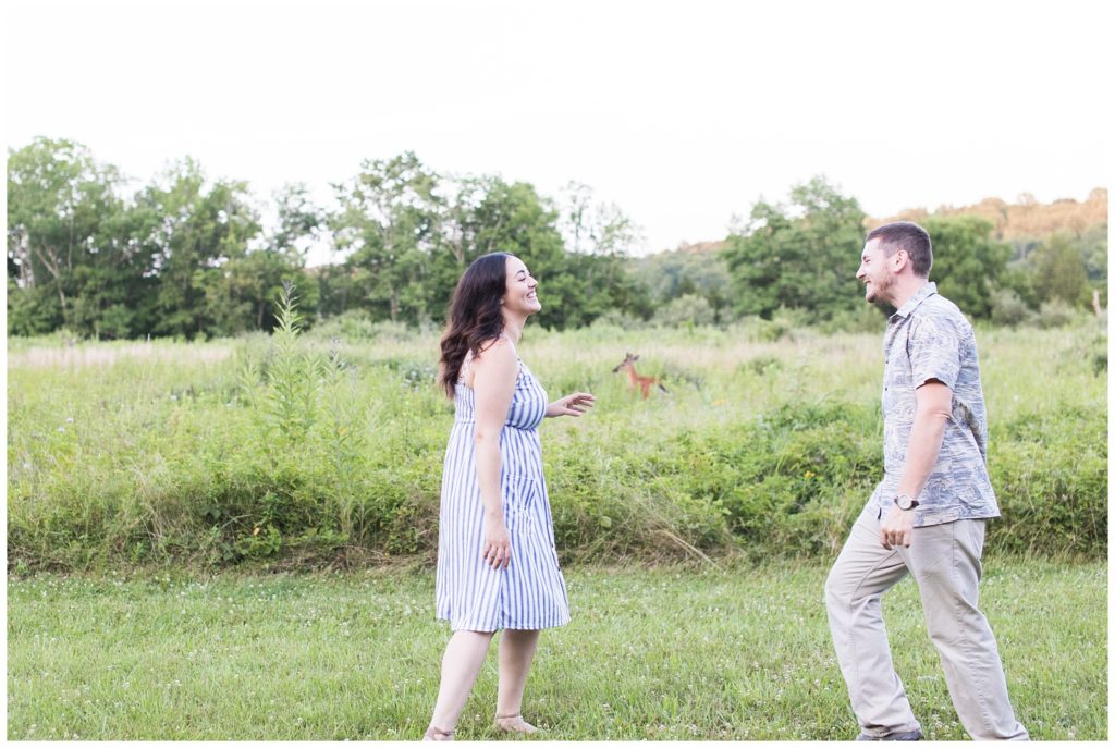 couple laughing together in a field