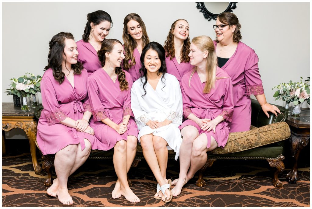 bridesmaids in matching robes posing for a photo 
