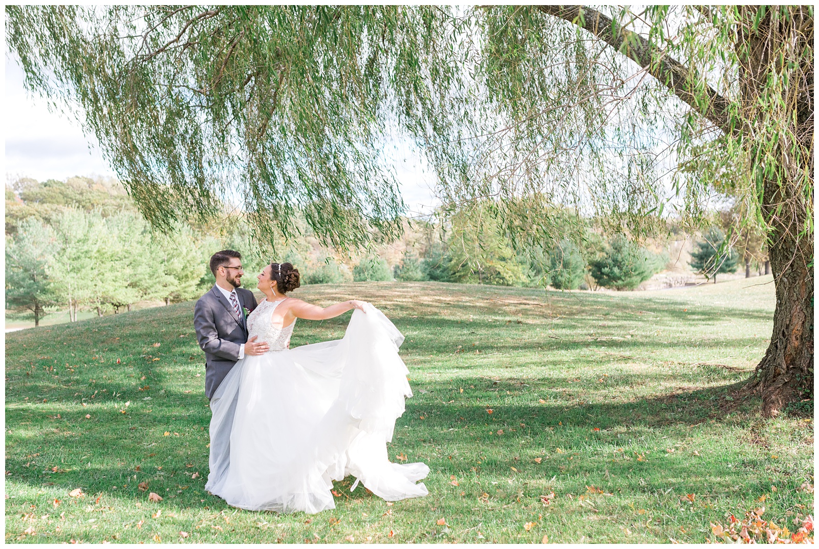 Husband and Wife under a willow tree during romantic portraits