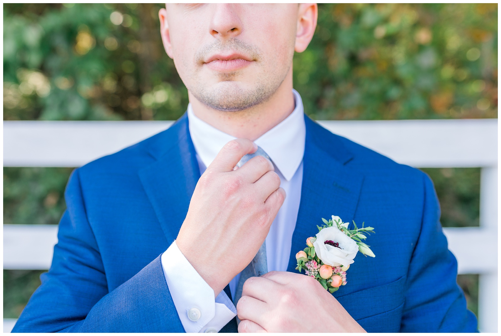 groom fixing his tie on his wedding day