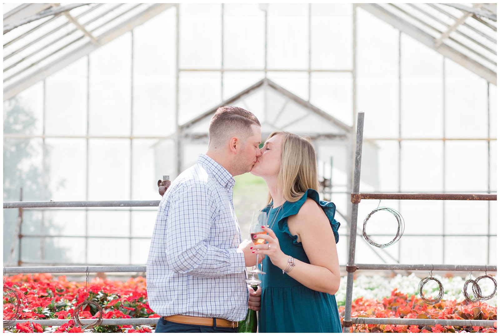 couple kissing in greenhouse